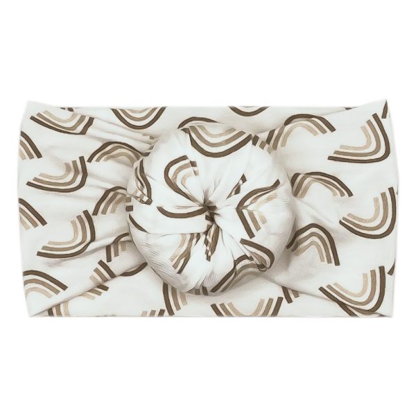 A white and brown Ellie - Bamboo Baby Knotted Headwrap with a rainbow pattern by Tiny Knot Co.