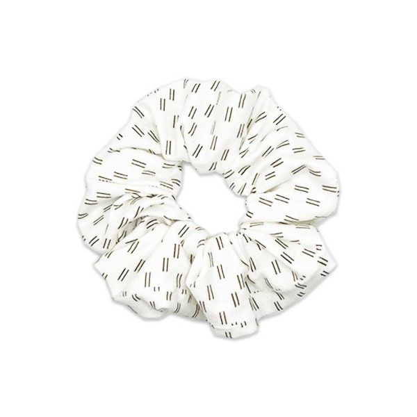 A white Luna - Bamboo Scrunchie with black and white stripes from Tiny Knot Co.