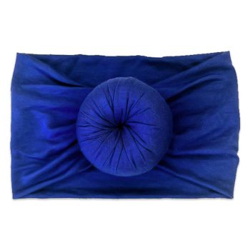 A blue ball from Tiny Knot Co resting on a blanket.